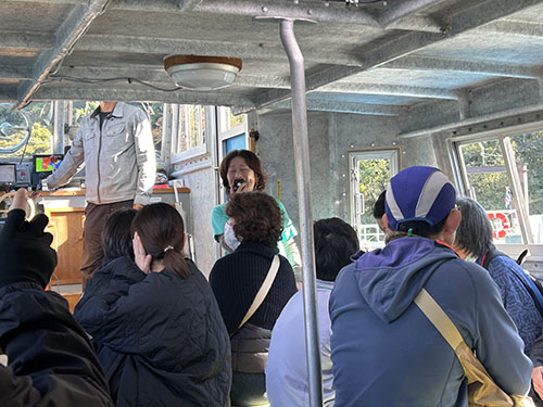 翔んでびわ湖の「大人のエコスクール」。チャーター船の中で説明するメンバー。