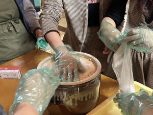 食養サークル　朝晴れ　活動のようす画像　陶器のカメにお団子を入れていく作業
